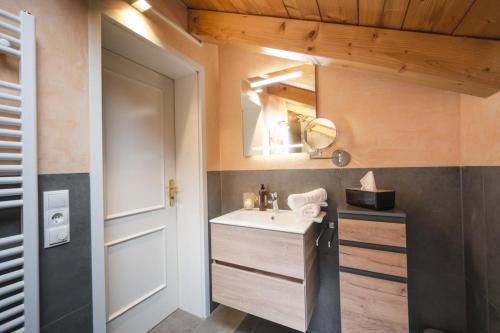 a bathroom with a sink and a mirror at Ferienhaus Die 12 mit 4 Schlafzimmern in Garmisch in Garmisch-Partenkirchen