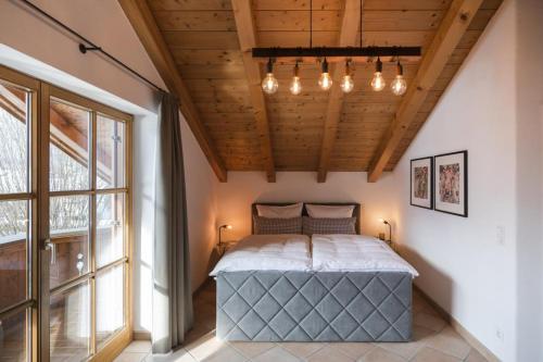 a bedroom with a large bed and a large window at Ferienhaus Die 14 mit Infrarotkabine in Garmisch-Partenkirchen