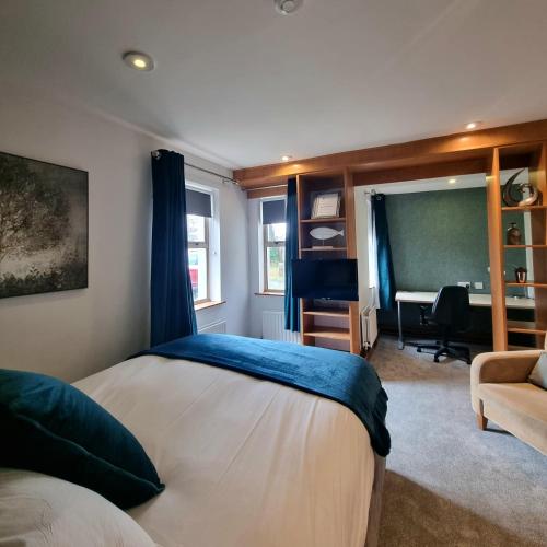 a bedroom with a bed and a desk in a room at Brennan Court Guest Accommodation in Limerick