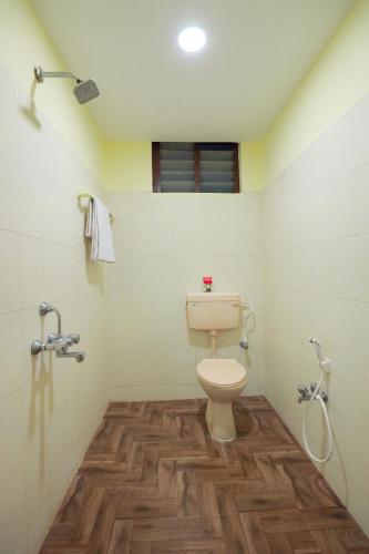 a bathroom with a toilet and a shower at Hotel Jeyam in Kanyakumari