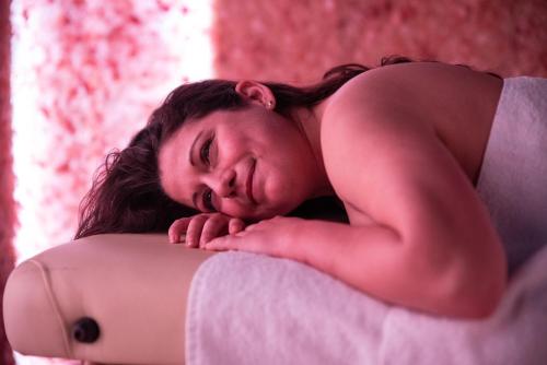 a young woman sleeping on top of a bed at Hotel Residence Montelago in Ternate
