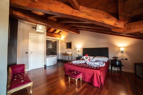 a bedroom with a bed and a table in a room at Hotel Residence Montelago in Ternate