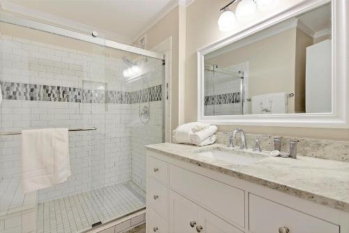 a white bathroom with a sink and a shower at 6A Seagrove Villa in Isle of Palms