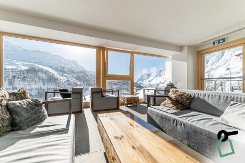 a living room with a view of a mountain at HOTIDAY Room Collection - Cervinia in Breuil-Cervinia