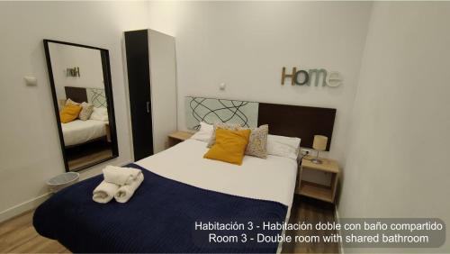 a bedroom with a large bed with a large mirror at Chueca Rooms Madrid in Madrid