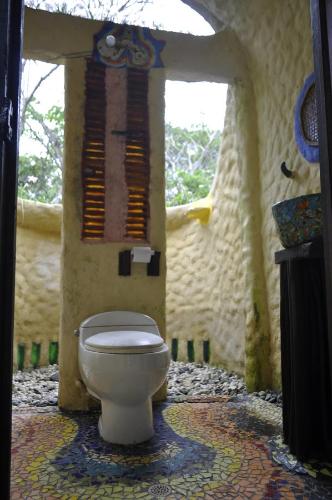 a bathroom with a toilet in a room at Acuali EcoHostal in Capurganá