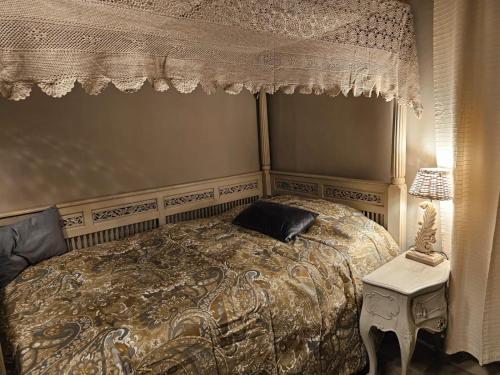 a bedroom with a bed with a canopy and a table at HomeStory 3 in Casa Canovetta