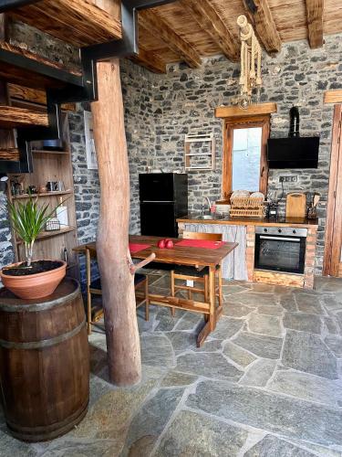 a kitchen with a wooden table and a table sidx sidx sidx sidx at Black Rock Agria in Agria