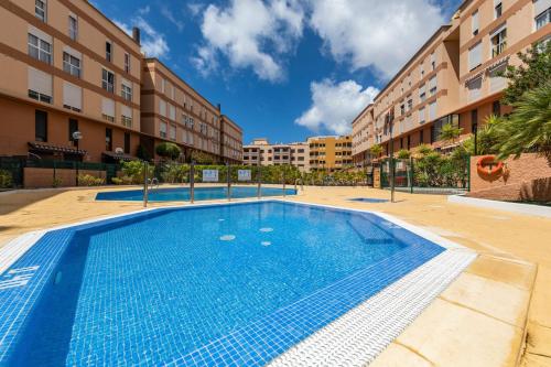 a swimming pool in front of a building at MEDANO4YOU Casa La Barca Sur in El Médano