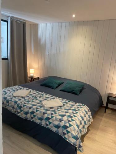 a bedroom with a bed with two towels on it at Maison L'Aiguille - 2 appartements, 5 chambres et table d'hôtes au pied de la montagne à la station de Laye in Laye