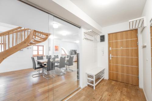 a room with a table and chairs and a staircase at Appartement Mountain View in Tamsweg