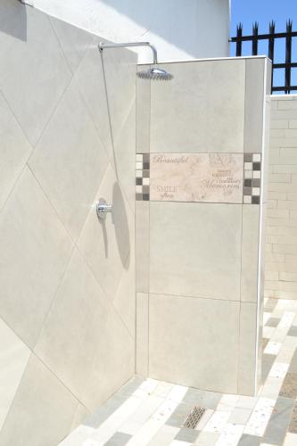 a shower with a glass door in a bathroom at Soldout Camp 3 in Soweto