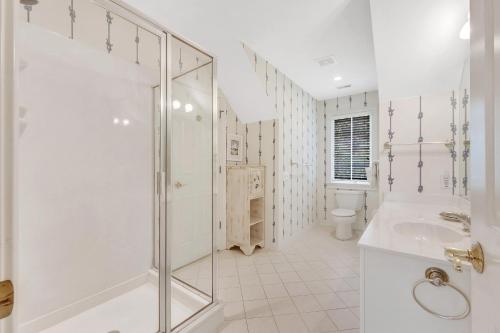 a white bathroom with a shower and a sink at MH3012: 3012 Marsh Haven in Seabrook Island