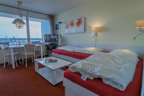 a hotel room with a bed and a dining room at Metropol-276 in Westerland