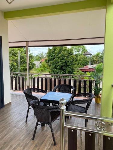 a patio with a table and chairs on a deck at Safiyyah Homestay / Roomstay in Kuala Berang