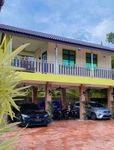 a house with cars parked in front of it at Safiyyah Homestay / Roomstay in Kuala Berang