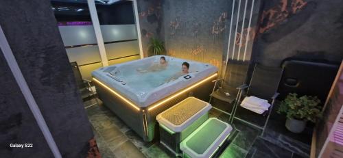a man in a bath tub in a bathroom at D&D Relax SPA Bucovina in Câmpulung Moldovenesc