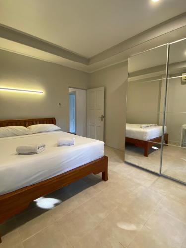 a bedroom with a large bed and a mirror at Samui Green Life in Bophut 
