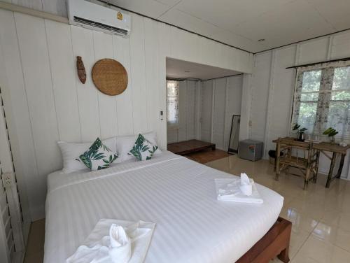 a bedroom with a large white bed in a room at The River Retreat Koh Mak in Ko Mak