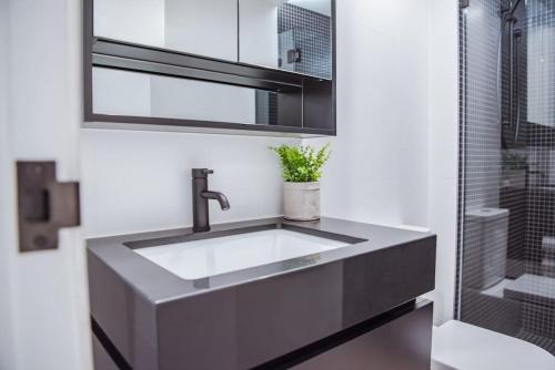 a bathroom with a sink and a shower at Ideal Cozy 1BR for your Urban Escape in Gabba in Brisbane