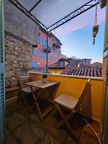 a patio with a table and chairs on a balcony at Kallisti Luxury rooms in Nafplio