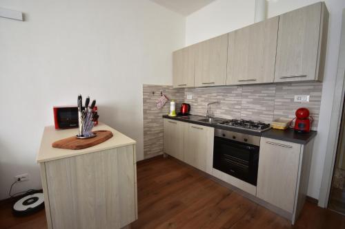 a kitchen with white cabinets and a stove top oven at Ca' Elide in Aosta