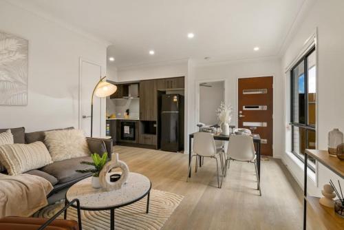 a living room with a couch and a table at Cozy 2BR brandnew home at Brown Plains in Browns Plains
