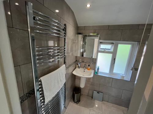 a small bathroom with a sink and a shower at Immaculate House for Professionals 2020 Renovation in Cove
