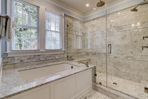 a bathroom with a tub and a glass shower at 317 Glen Eagle in Kiawah Island