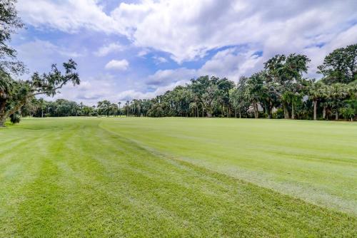 a field of green grass with trees in the background at GE317: 317 Glen Eagle in Kiawah Island