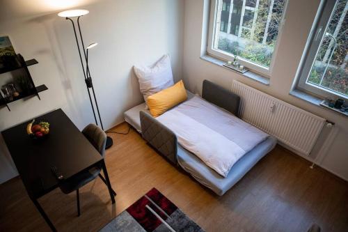 a small living room with a couch and a table at Loftcharakter auf 2 Etagen - Zentral in Essen! in Essen