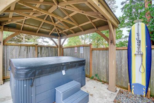 a surfboard sitting under a gazebo with a surfboard at Westport Home with Hot Tub 2 Blocks to Beach! in Westport