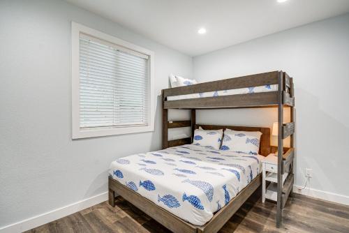 a bedroom with a bunk bed and a window at Westport Home with Hot Tub 2 Blocks to Beach! in Westport
