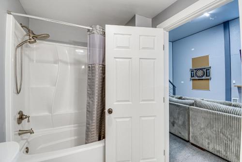 a bathroom with a shower and a white door at Westport Home with Hot Tub 2 Blocks to Beach! in Westport