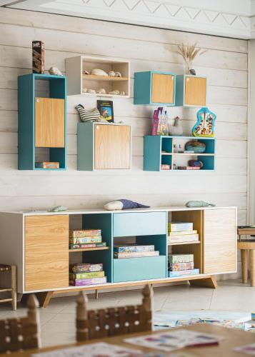 a childrens room with blue and wooden shelves at Paradis Plage Surf Yoga & Spa in Taghazout