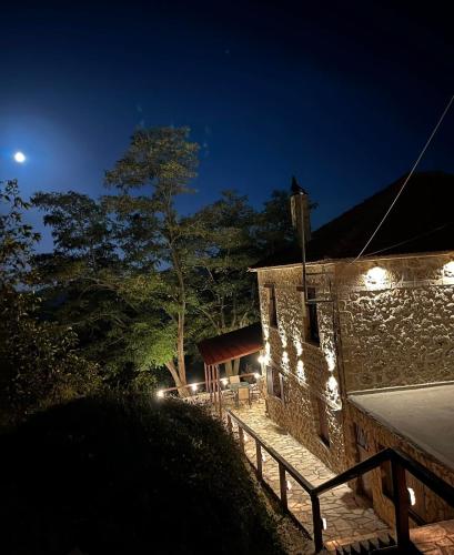 a stone building with lights on it at night at Παλαιό Λιθάρι in Ano Trikala