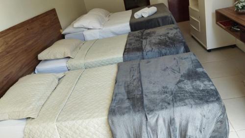 two beds in a hotel room with at Apto 2 quartos - Condomínio Frente Mar in Beberibe