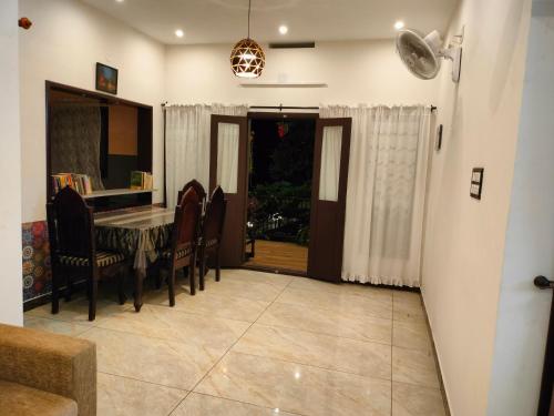 a dining room with a table and chairs at Gerards Home stay Fortkochi in Cochin