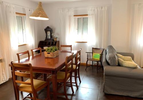 a dining room with a table and a couch at Casa d'Avó Maria - Paraíso no campo - 10pax, com piscina, vistas e vinhas in Marco de Canaveses