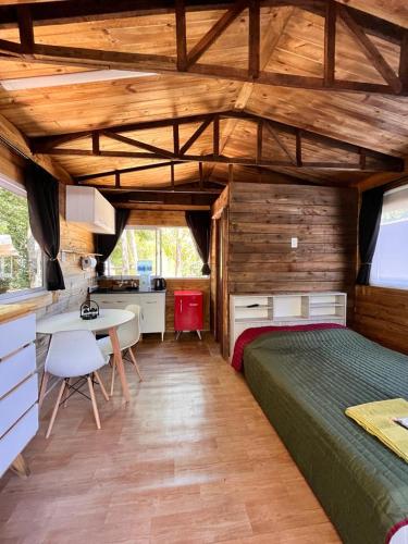 a bedroom with a bed and a desk in a room at Mostrotel - Tu Hotel en el Delta in Tigre