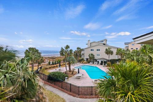 an aerial view of a house with a swimming pool and the ocean at SG3C: 3C Seagrove Villa in Isle of Palms