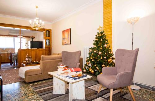 a living room with a christmas tree and a couch at DORIEON 26 Sparti Lakonias in Sparti