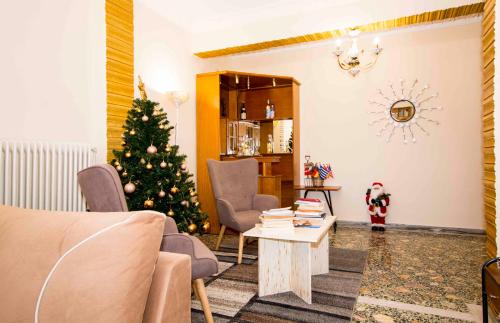 a living room with a christmas tree in the corner at DORIEON 26 Sparti Lakonias in Sparti
