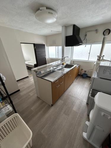 a kitchen with a sink and a counter top at 小樽民泊太田5号館 in Kita-hamachō