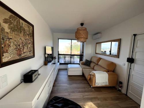 a living room with a couch and a table at Penthouse Terraço de Coimbra in Coimbra