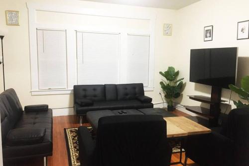 a living room with a couch and a table at Comfy 4 Bed 1 Bath with Wi-fi in College Area in Springfield