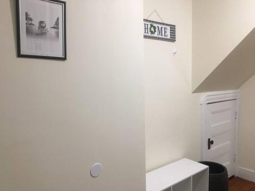 a white bathroom with a sink and a picture on the wall at Comfy 4 Bed 1 Bath with Wi-fi in College Area in Springfield