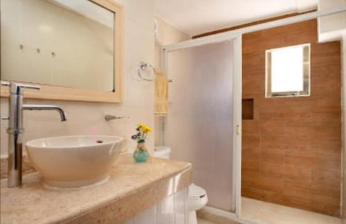 a bathroom with a sink and a toilet at Perfect vacation getaway,Ocean View,Wifi, Beach in Cancún