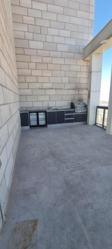 an empty parking lot with a brick wall at JTower Royal Suites - The Penthouse - Alefimmoed in Jerusalem