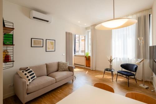 a living room with a couch and a chair at Realkasa Gallery Blue Suite in Bologna